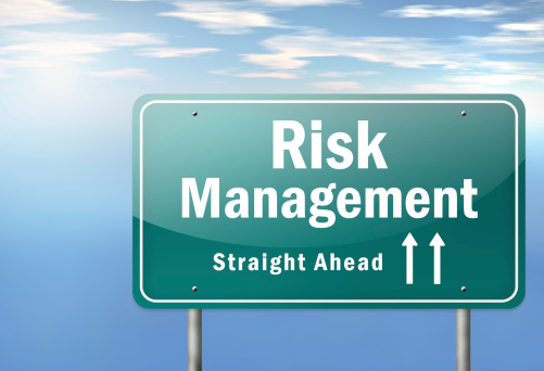 road sign with the words risk management straight ahead