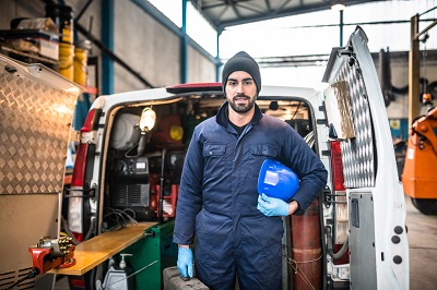 image of man standing behind commercial auto